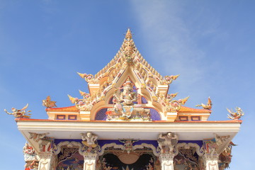 BANGKOK, THAILAND - JUNE 11, 2016 : High Relief Sculpture, statue of imaginary god on church gable Wat Pariwat Temple on blue sky background, Bangkok, Thailand