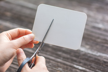 Wall Mural - woman cutting paper by scissors