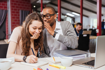 Wall Mural - Happy young business people working together and laughing