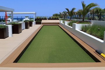 Inviting bocce ball court with artificial turf.