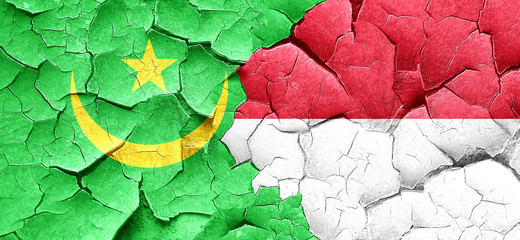 Mauritania flag with Indonesia flag on a grunge cracked wall