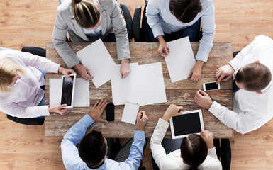 Canvas Print - close up of business team with papers and gadgets