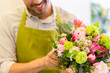 close up of florist man with bunch at flower shop