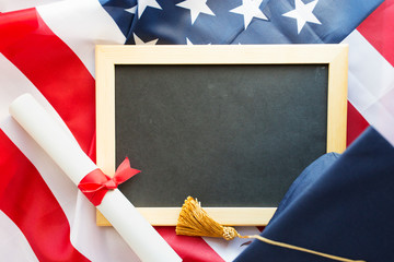 Wall Mural - board, bachelor hat and diploma on american flag