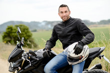 Handsome Young Man Biker With White Helmet Riding Black Motorcycle