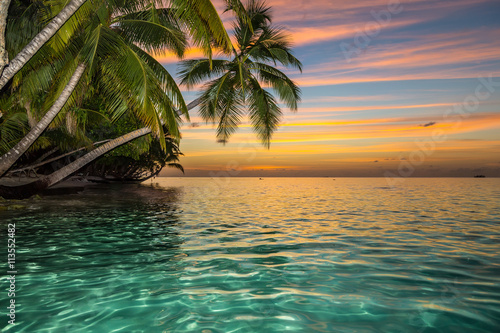 sunset on tropical island w...
