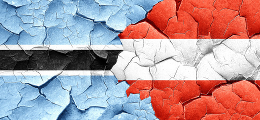 Botswana flag with Austria flag on a grunge cracked wall