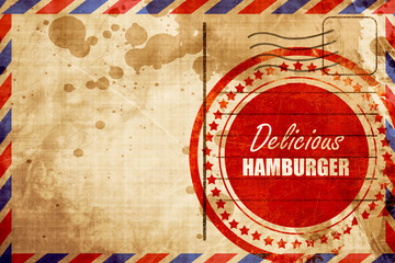 Delicious hamburger sign, red grunge stamp on an airmail backgro