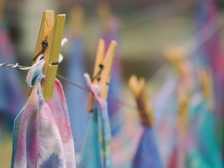 Soft focus clothespin hanging with tie dye on blurred background, hand made tie dye background