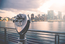 Pay Binoculars In Long Island City With The Manhattan Skyline At Sunset In The Background. Travel, Vacation, Sightseeing, New York, Tourism, And Urban Living Concept