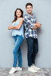 © Drobot Dean - Couple standing with arms crossed over gray background