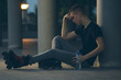 © cherryandbees - Rollerblader sitting on the floor. dark night scene.