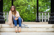 Young beautiful woman sitting on the stairs in the park