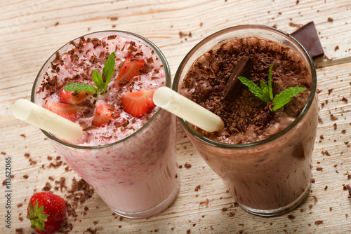 Fotografie, Obraz chocolate and strawberry milkshake on wooden background
