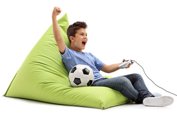 Wall Mural - Joyful kid playing football video game