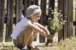 © mikitiger - boy with a bouquet of daisies near old wooden fence