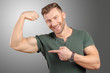 © fotofabrika - smiling man showing biceps