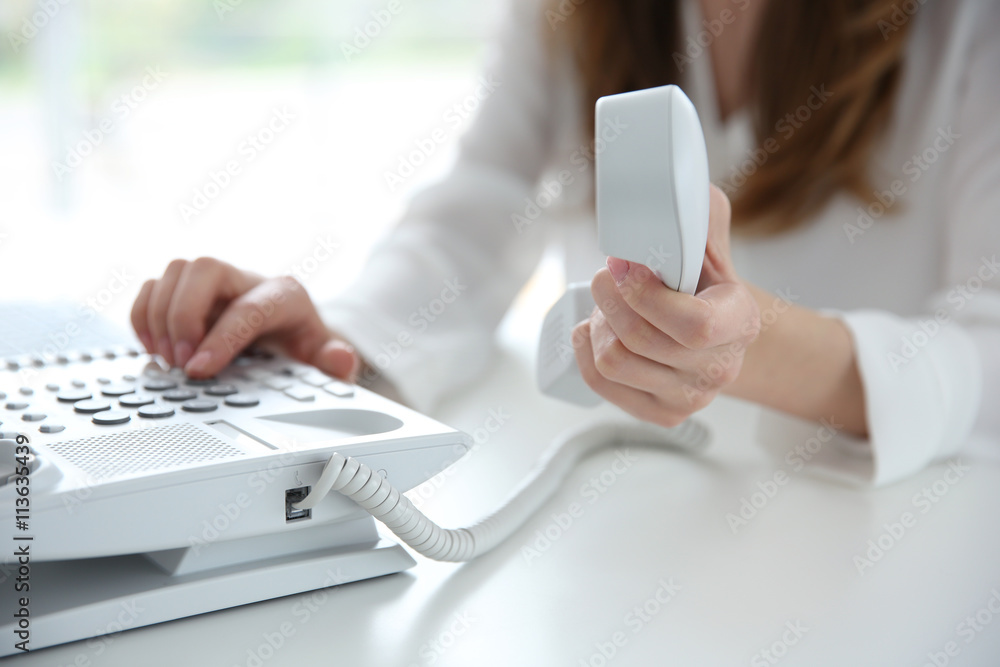 Businesswoman with office IP telephone