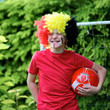 Happy young belgian boy having fun supporting Red Devils team during european football championship EURO 2016. Kid in Belgian national tricolour with painted flag on his face playing soccer outdoors.