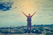 © nuiiko - Man stay on the top of mountain and raising his hands.