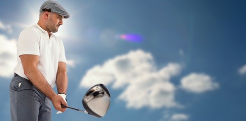 Wall Mural - Composite image of golf player taking a shot