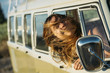 © Jose Luis Carrascosa Martinez/ADDICTIVE STOCK - Teen girl sticking head out of van in motion
