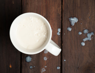 Wall Mural - Glass of milk on rustic wooden background