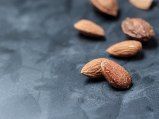 Canvas Print - Almonds on a black slate background,