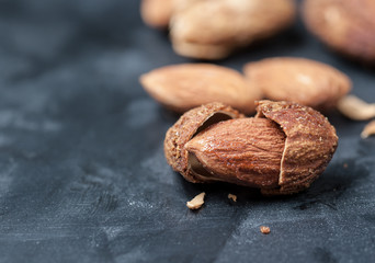 Canvas Print - Almonds on a black slate background,