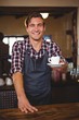© WavebreakMediaMicro - Waiter handing over a coffee