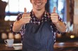 © WavebreakMediaMicro - Smiling waiter with thumbs up