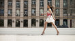 © Andrey_Arkusha - Young beautiful brunette woman in white flowers dress walking on