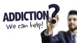 Business Man Pointing the Text: Addiction? We Can Help!