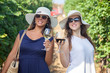 © FotoCuisinette - Happy women in vineyard with wineglasses.