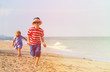 © nadezhda1906 - happy little boy and girl running on sand beach