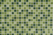 Toilet Wall Of Made Of Different Hues In Green Tiles.