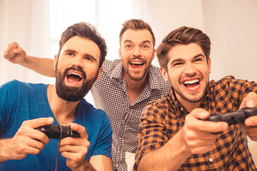 Canvas Print - Yeah! close up photo of excited happy cheerful men play video ga