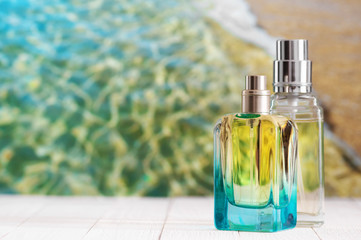 Perfume bottles against sea