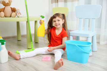 Cute little girl cleaning her room