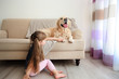 © Africa Studio - Little girl and big kind dog in the living room