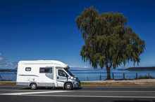 A Campervan Driving Along The Coast Of Lake Taupo In North Island Of New Zealand