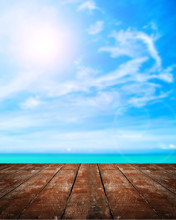 Beautiful Beach With Wooden Plank On Blue Sky With The Sun Background.