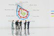 © ImagineDesign - Selective focus of miniature businessman meeting and discuss with spider chart background as partnership and investment concept.