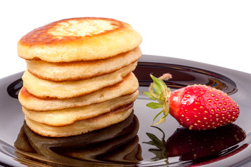 Wall Mural - fritters on a plate with strawberries isolated white background