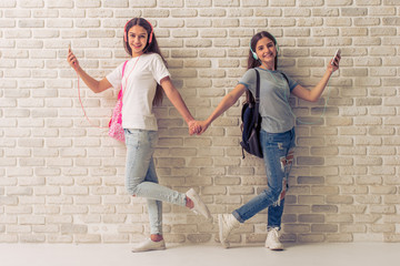 Wall Mural - Attractive teenage girls with gadgets