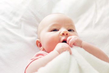 Wall Mural - Happy baby girl lying on her blanket