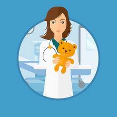 Canvas Print - Pediatrician doctor holding teddy bear.