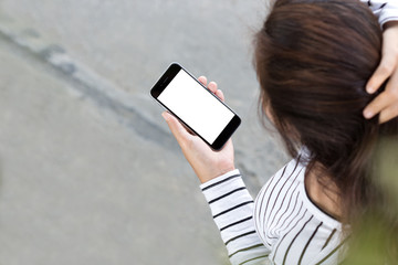 Aufkleber - woman looking on phone and walking on road, third-person view