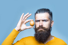 Serious Bearded Man With Egg