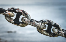 Old Rusty Anchor Iron Ship Chain In Sea Port.